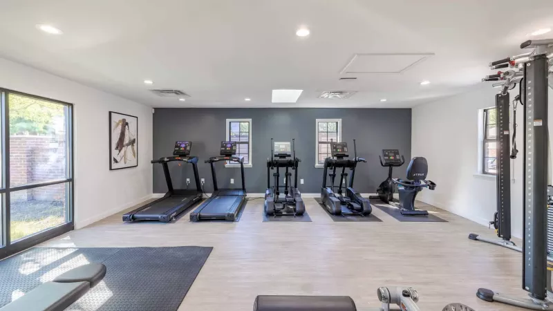 Bright, open fitness center with an abundance of workout machines and mats to choose from.