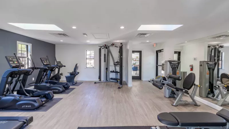 Fitness center with ample amount of machinery.