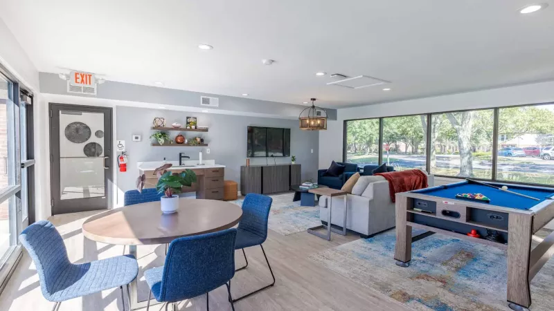 Clubhouse that includes multiple seating choices, and a pool table.