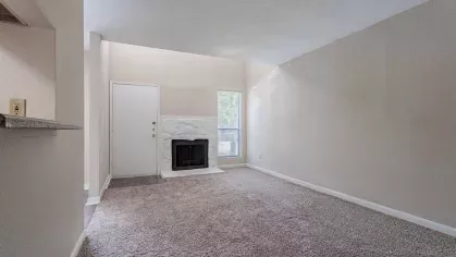 Large, open living room with fireplace. 