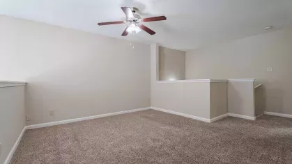 Open bedroom with overhead ceiling fan and light.