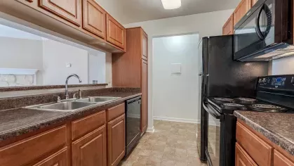 Large kitchen with upgraded black appliances. 