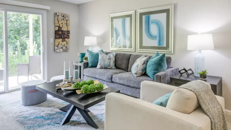 Large, bright living room with expansive sliding glass door for easy access to balcony.