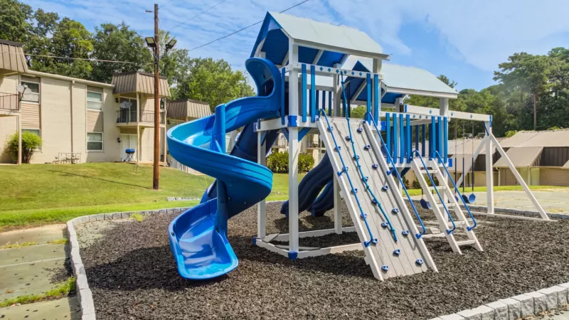 Updated playground space with playground equipment for residents to play on.