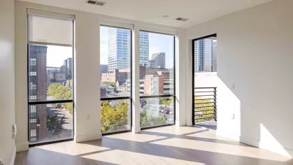 Industry Columbus open, bright bedroom with large windows for natural sunlight. 