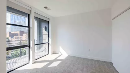 Industry Columbus open, bright bedroom with large windows for natural sunlight. 