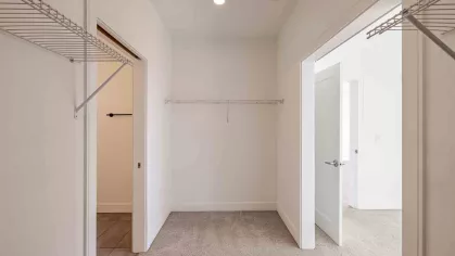Large closet with access to the bedroom and bathroom. 