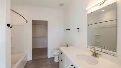 Bright, updated bathroom with shower and bathtub combination.