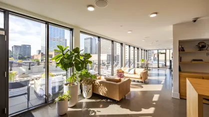 Bright clubhouse with greenery and ample amount of seating. 