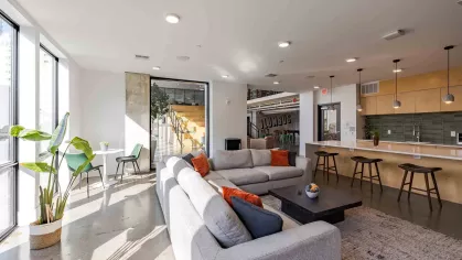 Bright clubhouse with greenery and ample amount of seating. 