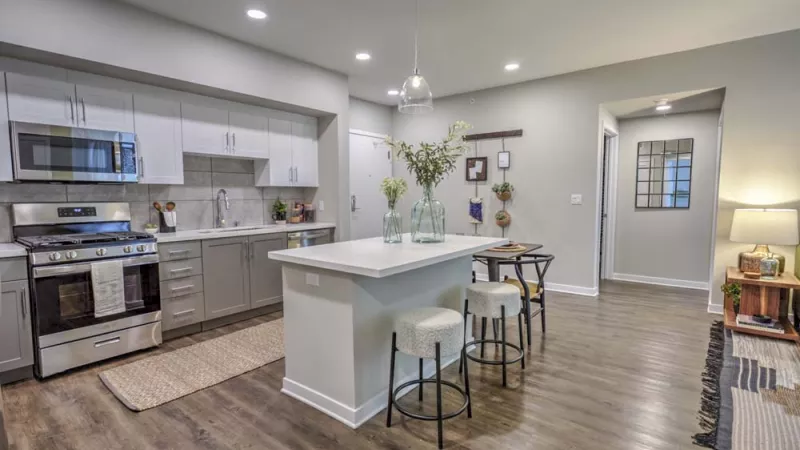 Bright, open kitchen with overhead lighting and updated appliances.