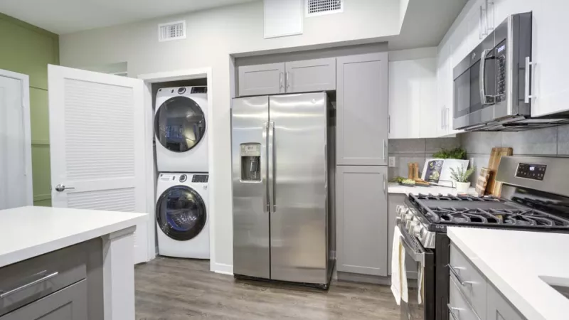 Bright, open kitchen with dedicated laundry space.