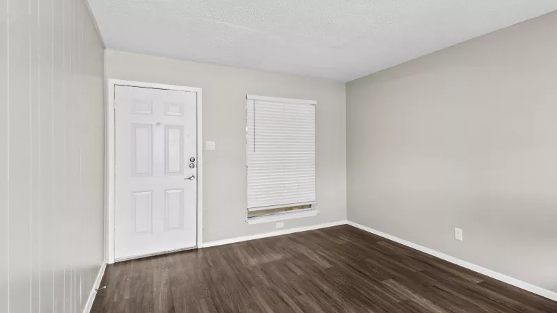 Open living room with updated flooring. 