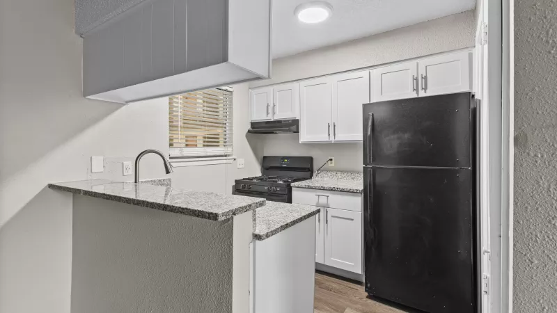 Bright, open kitchen with updated appliances and fixtures. 
