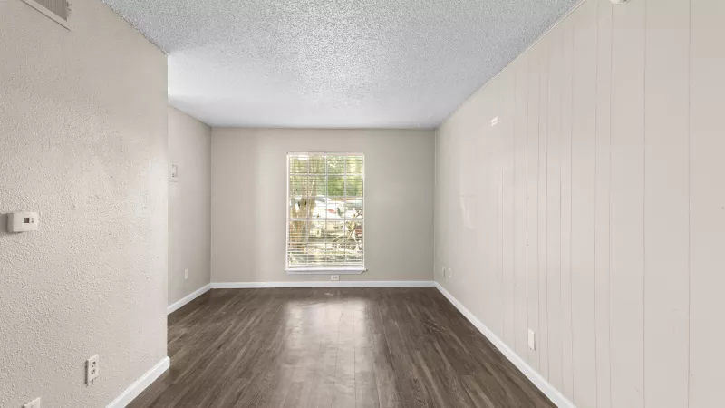 Open living room with bright, large window for residents to enjoy. 