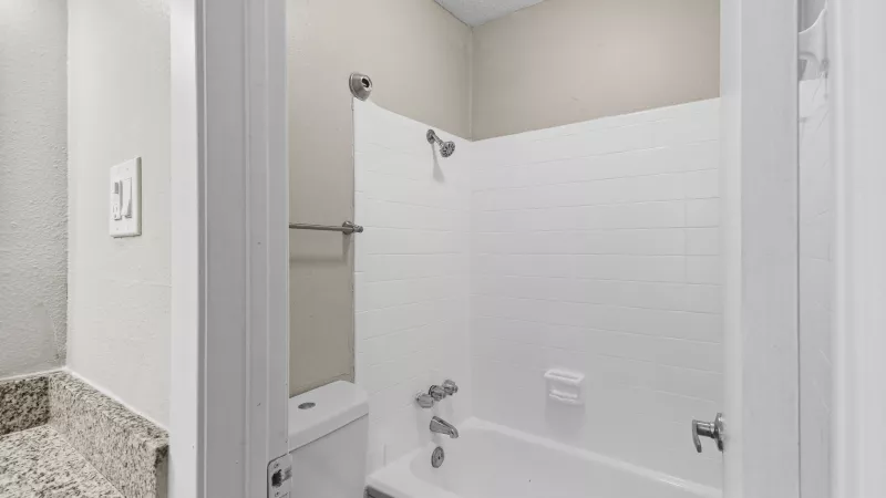 Separate toilet and shower/tub area. 