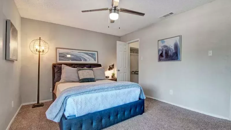 Cozy bedroom with a soft bedspread and unique decorative lighting.