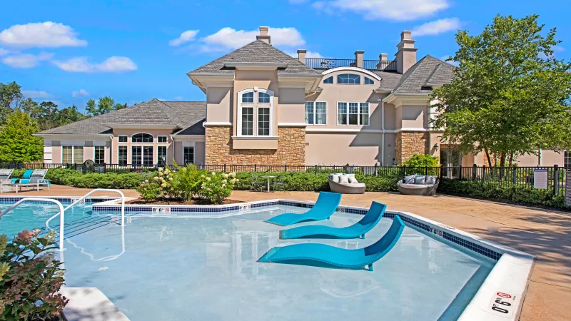 Close-up of the luxurious poolside area featuring shallow water seating and modern architecture at The Grove Somerset Apartments.