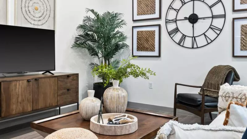 A contemporary living space with a neutral color palette, natural elements, and an inviting entertainment setup.