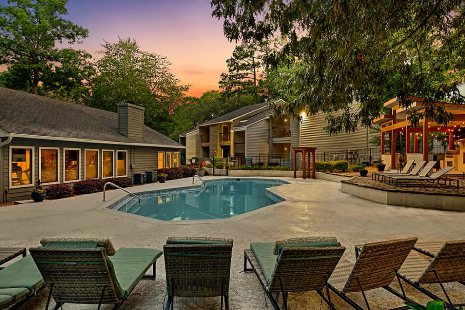Evening poolside ambiance with lit seating areas and a serene atmosphere.