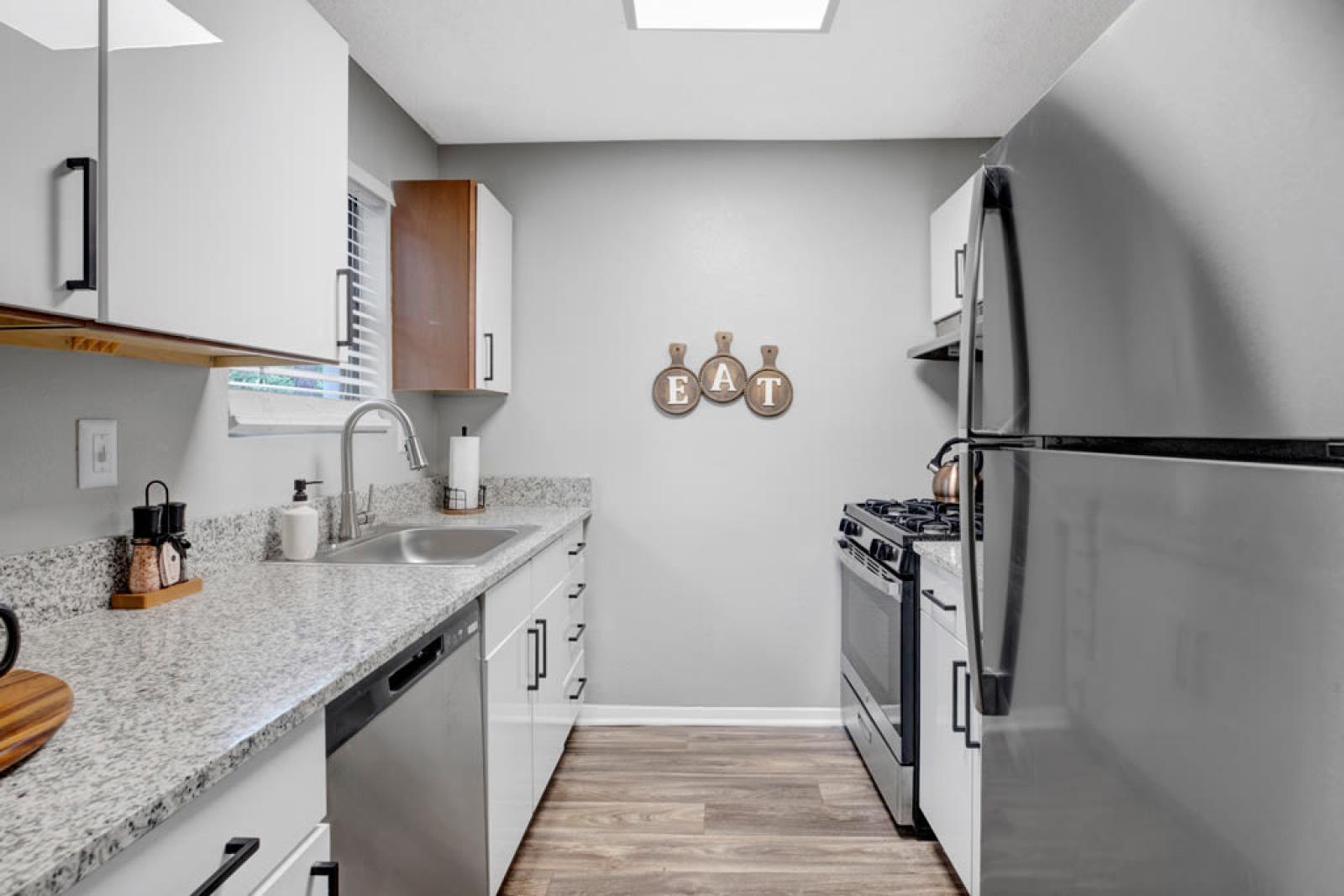 Contemporary kitchen with stainless steel appliances, granite countertops, and elegant cabinetry.