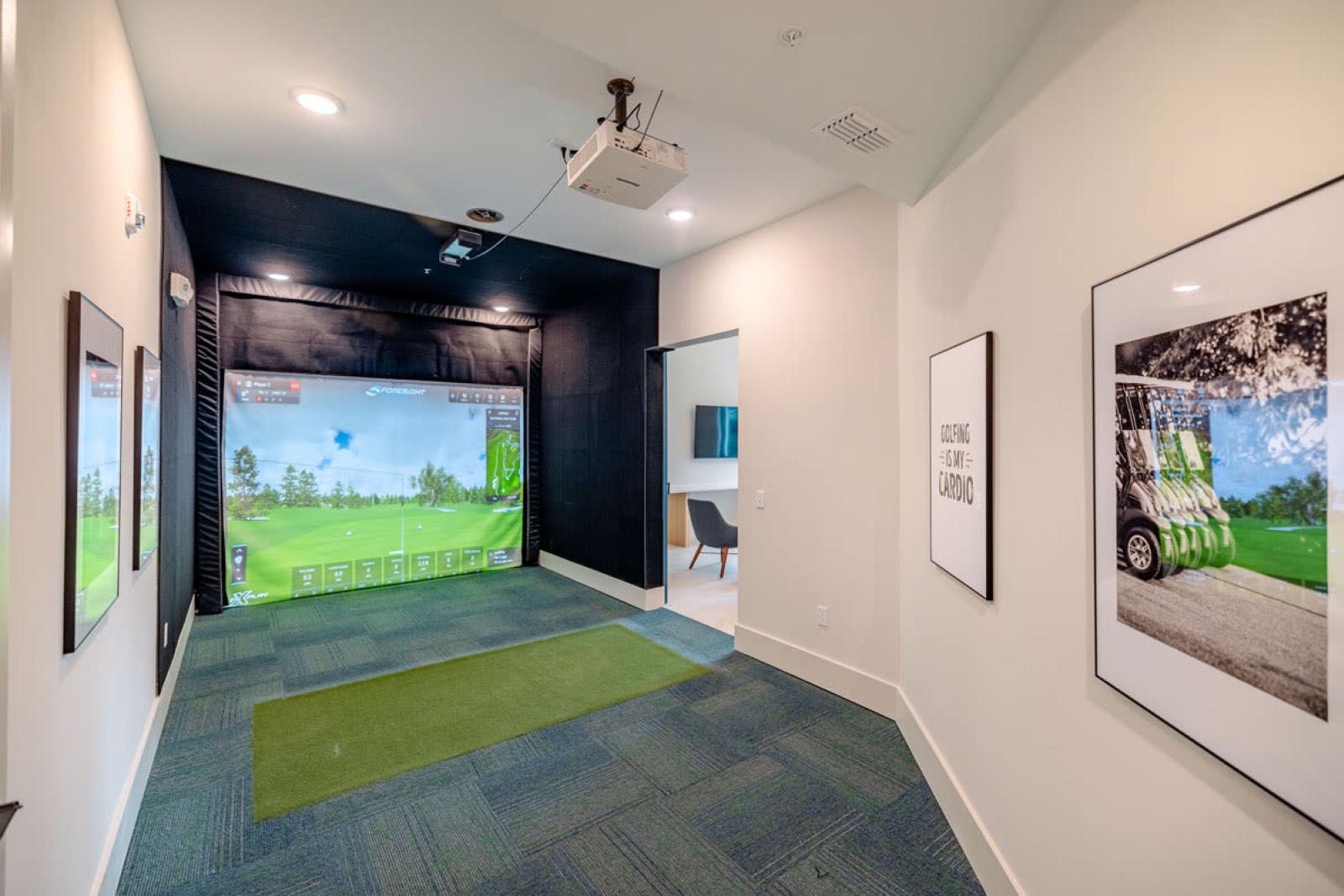 A high-tech golf simulator room at Tropia Wellen Park Apartments, providing an immersive virtual golfing experience for residents.