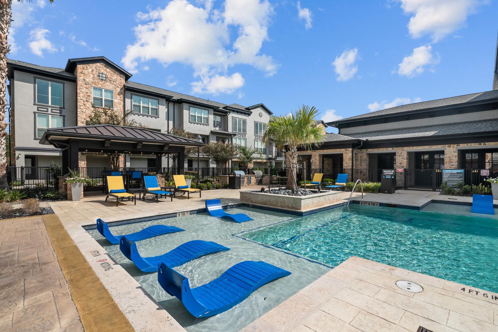 A luxurious poolside with chaise loungers, cabanas, and vibrant landscaping, perfect for relaxation.
