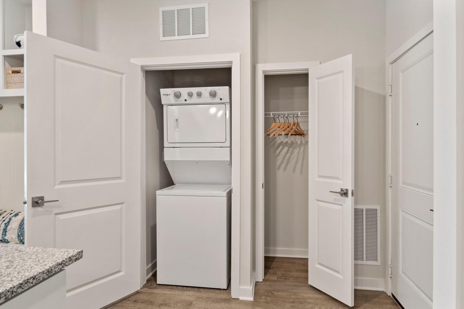 Walk-in closet with white shelving, neatly folded towels, and ample space for hanging clothes and storage.