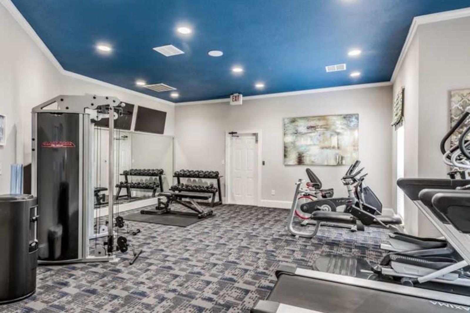 Modern fitness center with cardio and strength training equipment at The Landings of Conroe Luxury Apartments.