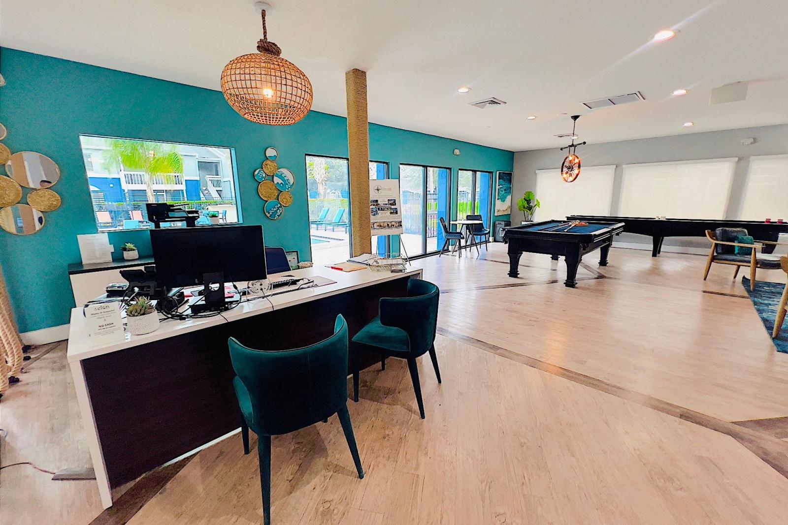 Cozy lounge area with teal sofas, vibrant decor, and a striking octopus mural on the wall, offering a unique and stylish spot for relaxation.