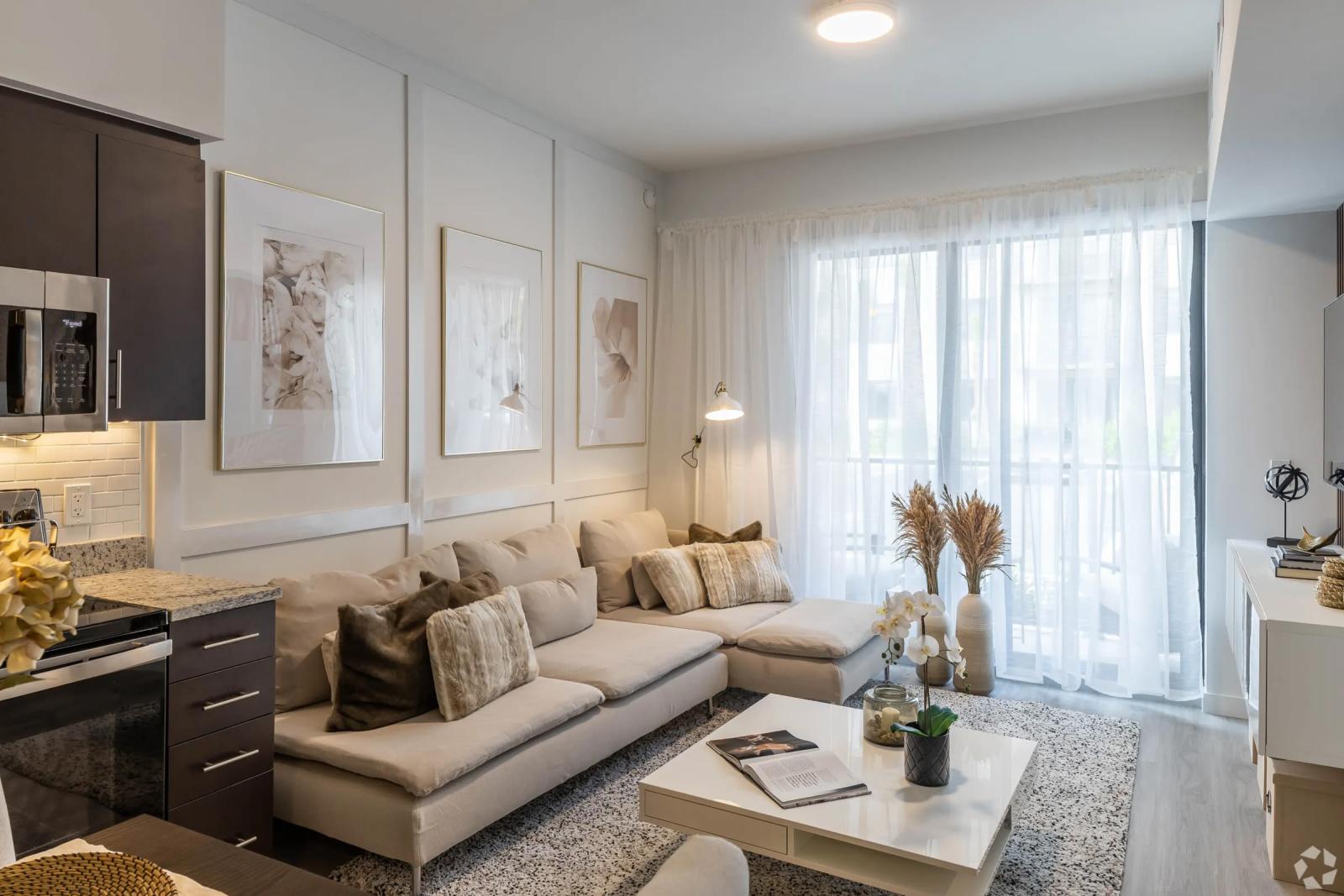 Modern living room interior at Pine Ridge Luxury Apartments, featuring a cozy sectional sofa, soft lighting, and elegant wall decor.