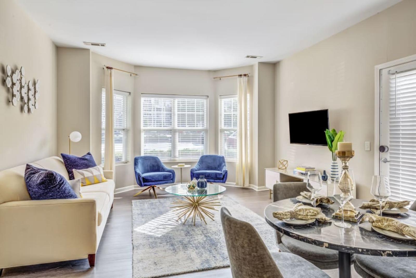 A spacious living and dining area in an Oak Enclave apartment, with natural light filling the room, elegant furnishings, and a modern open-concept layout.