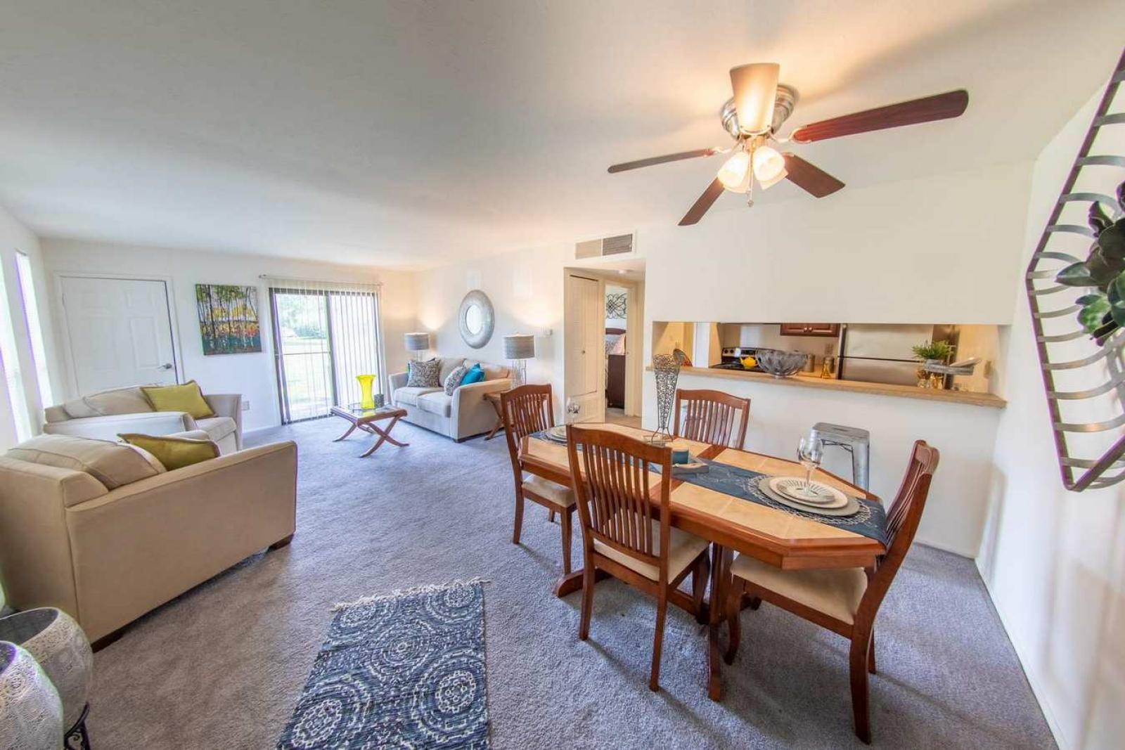 Stylish and inviting living and dining area with contemporary decor, plush seating, and an open floor plan at Forest Creek Apartments