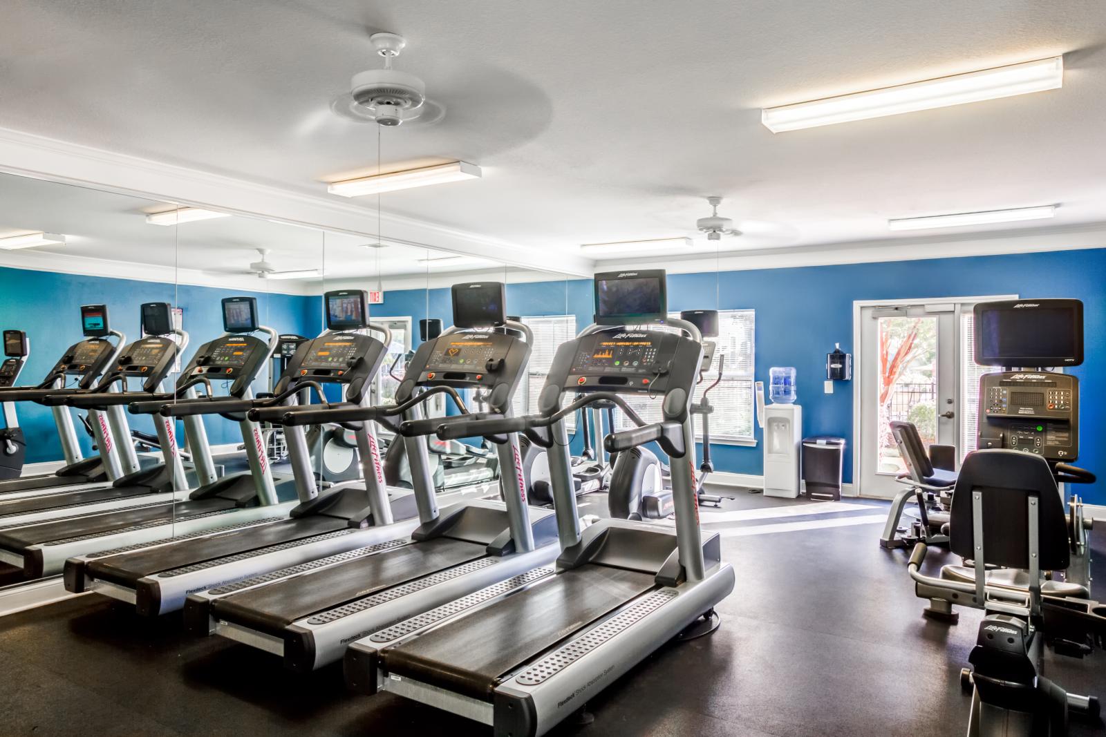 Fitness center with treadmills and cardio machines in front of mirrored wall at Grandview at Lake Murray