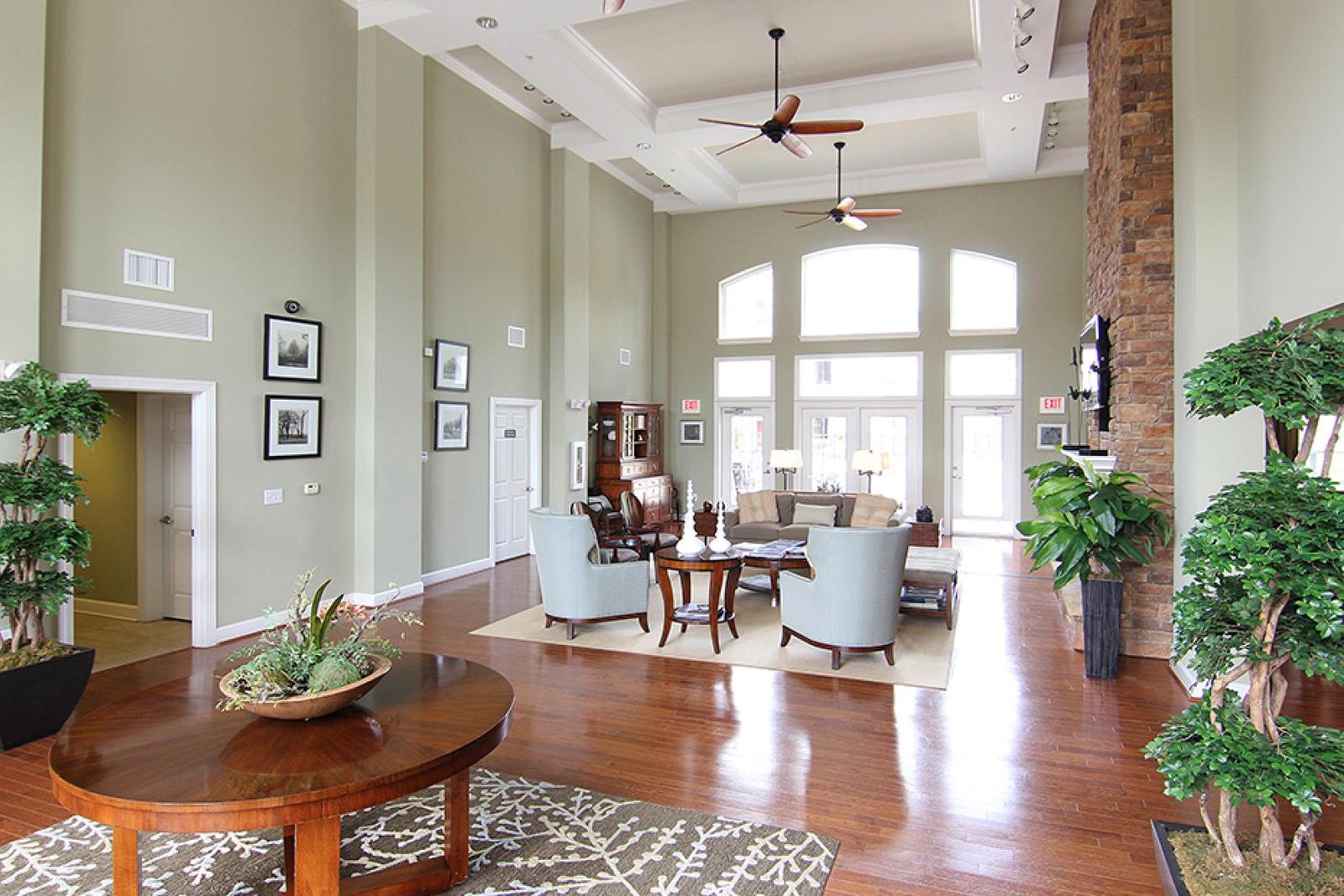 Elegant resident clubhouse at Reed Creek Apartments with high ceilings, lounge seating, and contemporary decor.