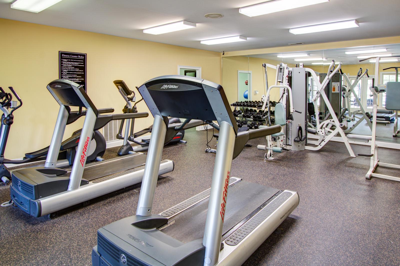 Apartment community gym at The Heights at Lake Murray offering modern workout equipment and mirrored walls for convenience