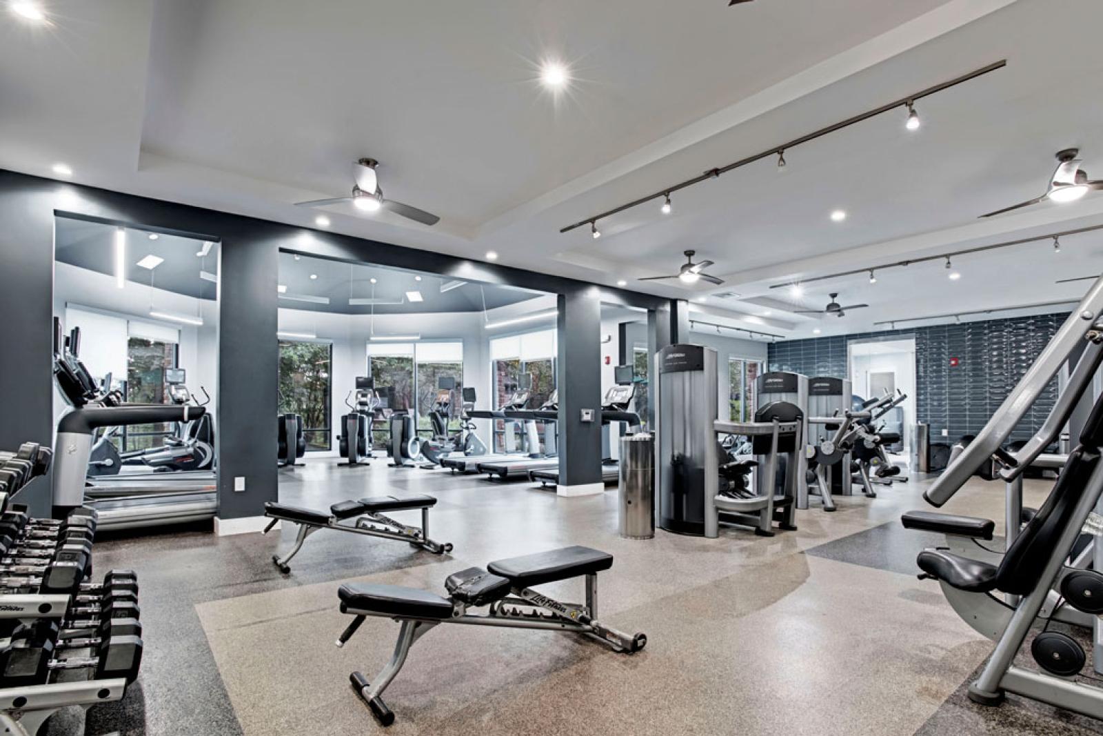 Bright, open gym with state-of-the-art machines and equipment.