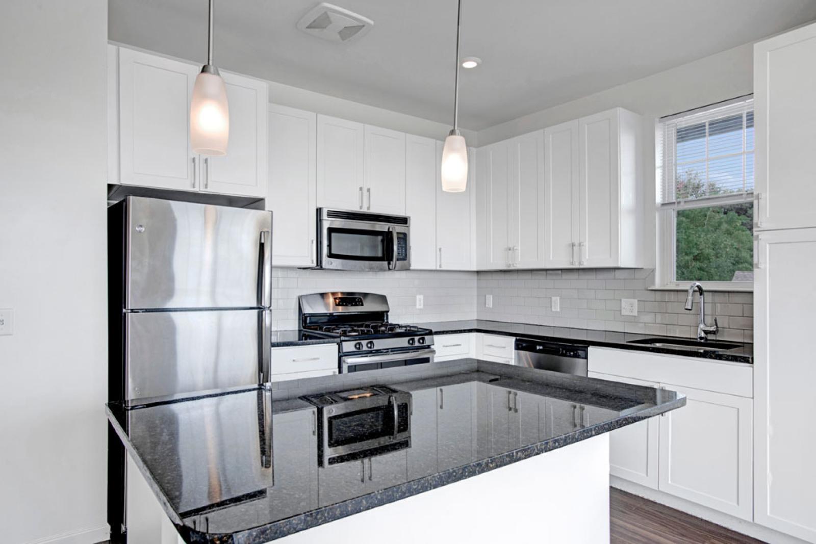 Bright, spacious kitchen with stainless steel appliances.