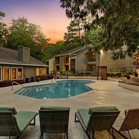 Evening poolside ambiance with lit seating areas and a serene atmosphere.