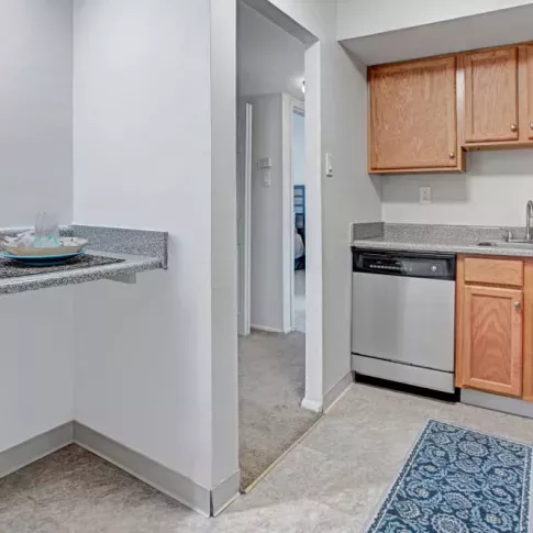 A compact dining nook with a granite breakfast bar set up with tableware.