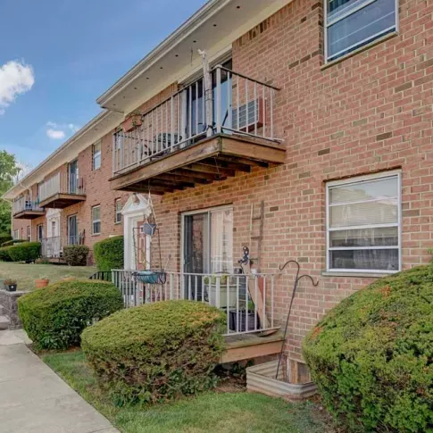 Cozy private balconies and brick exterior at Washington Gardens Apartments, providing a charming and comfortable living space.