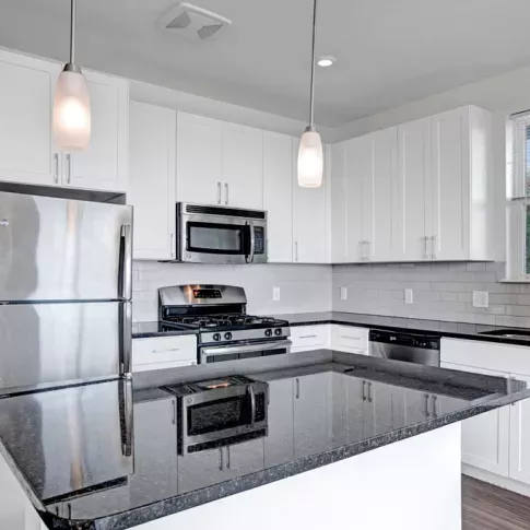 Bright, spacious kitchen with stainless steel appliances.