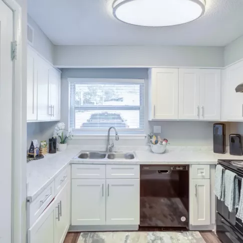 Updated kitchen with sleek appliances, and ample cabinet space.