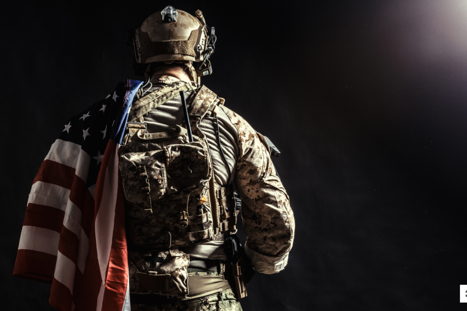 Military person holding American flag