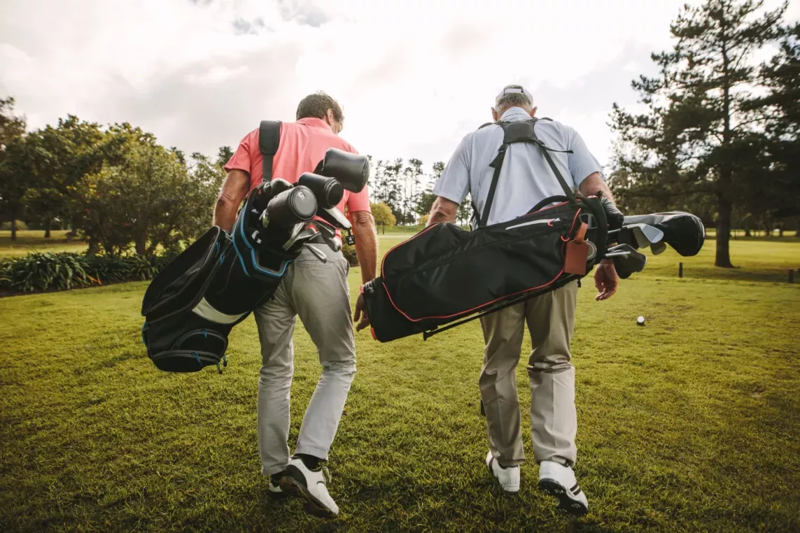 Two men walking on a golf course