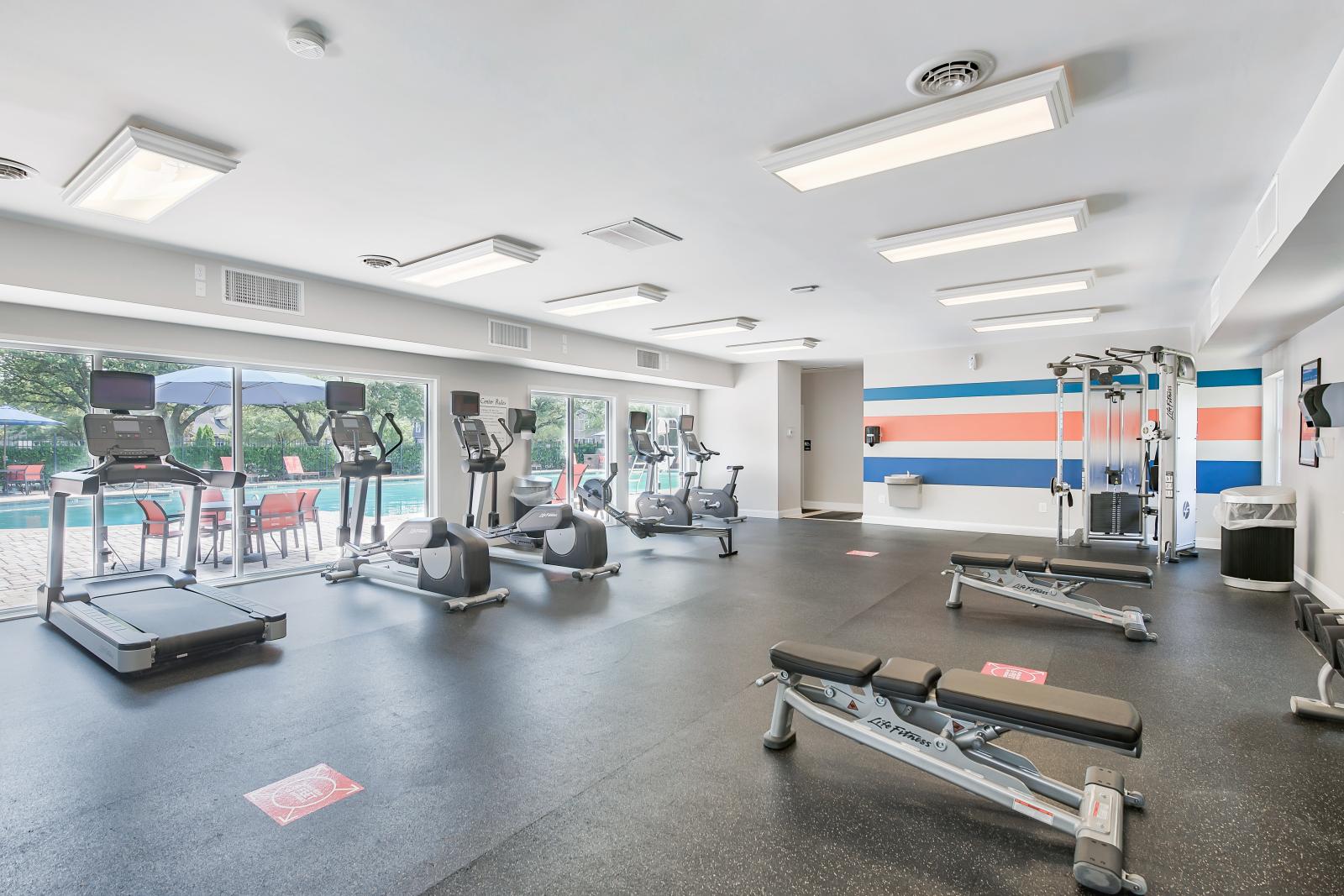 Fully equipped fitness center featuring cardio machines, free weights, and training equipment for a healthy lifestyle.