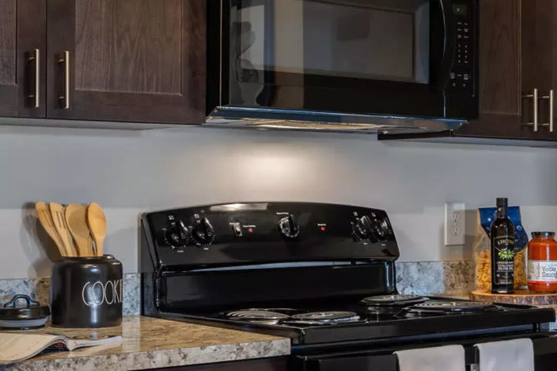 A modern kitchen with sleek cabinetry and appliances at Walden Lakes Apartments.