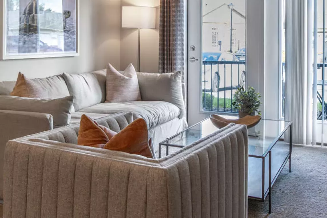 A cozy and inviting living room with access to a private balcony.