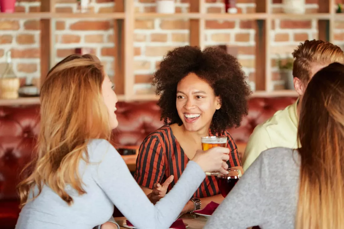 A group of friends sitting at a restaurant