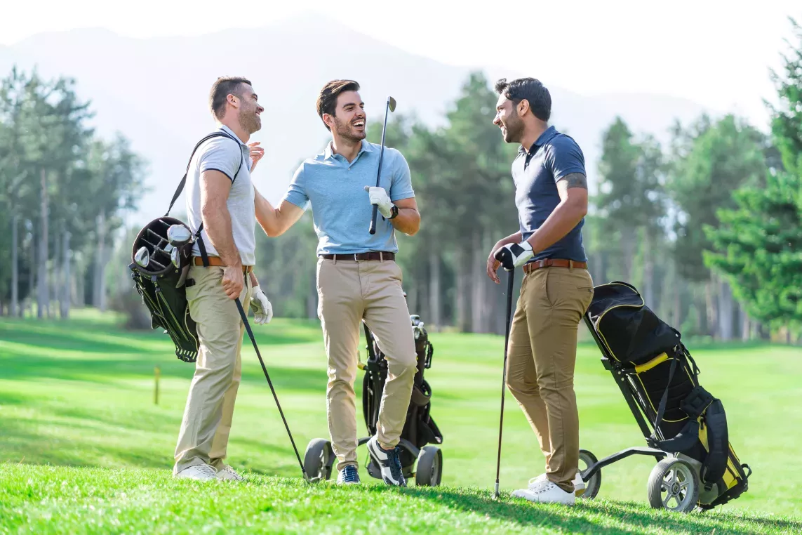 People laughing a talking at a golf course